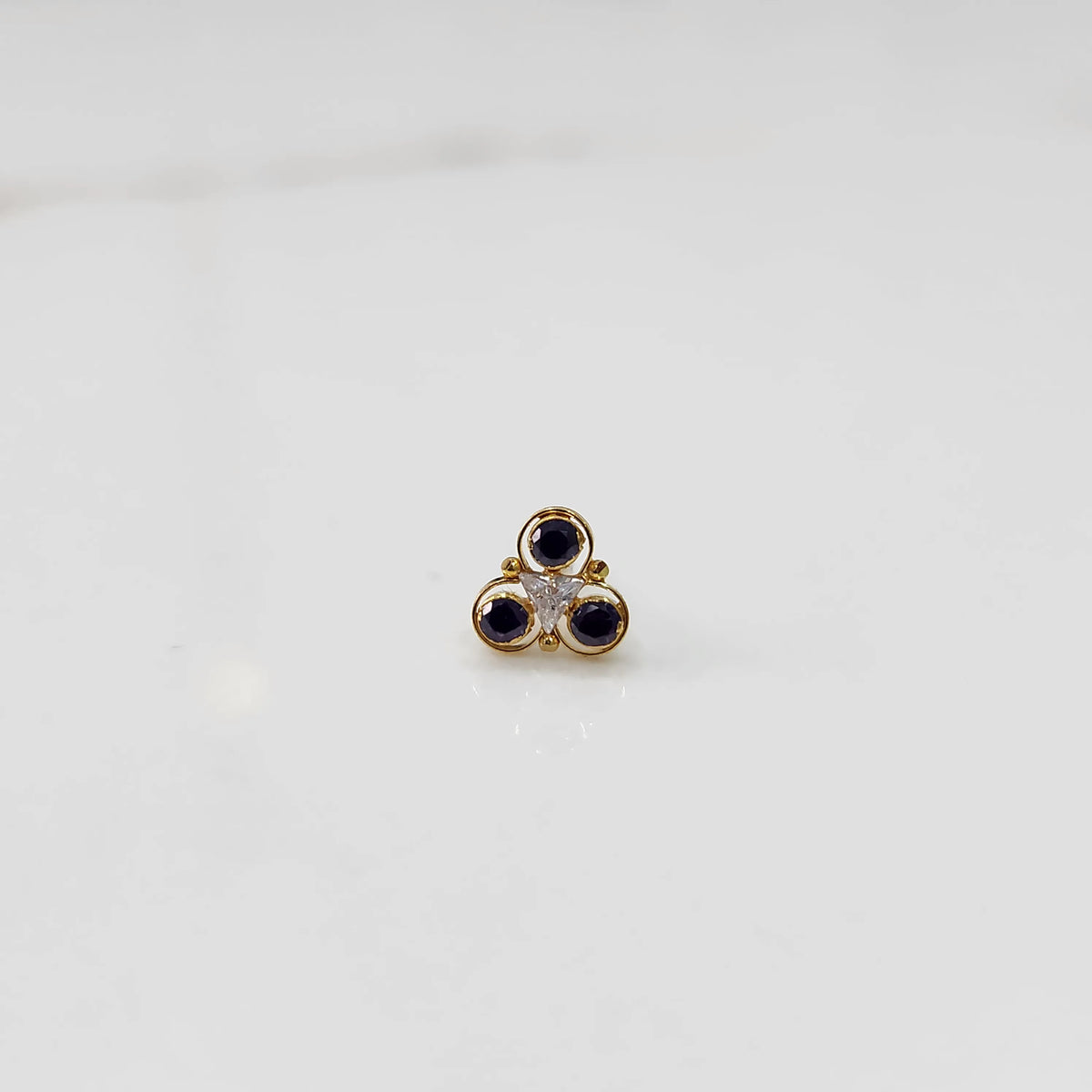 Gold ring with three-stone cluster in blue and clear stones