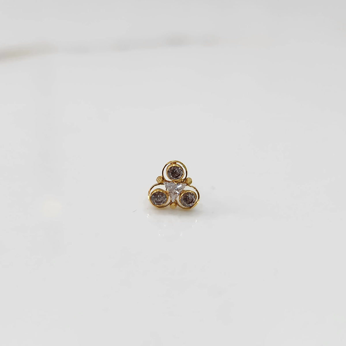 Top view of gold ring with brown and clear stone cluster
