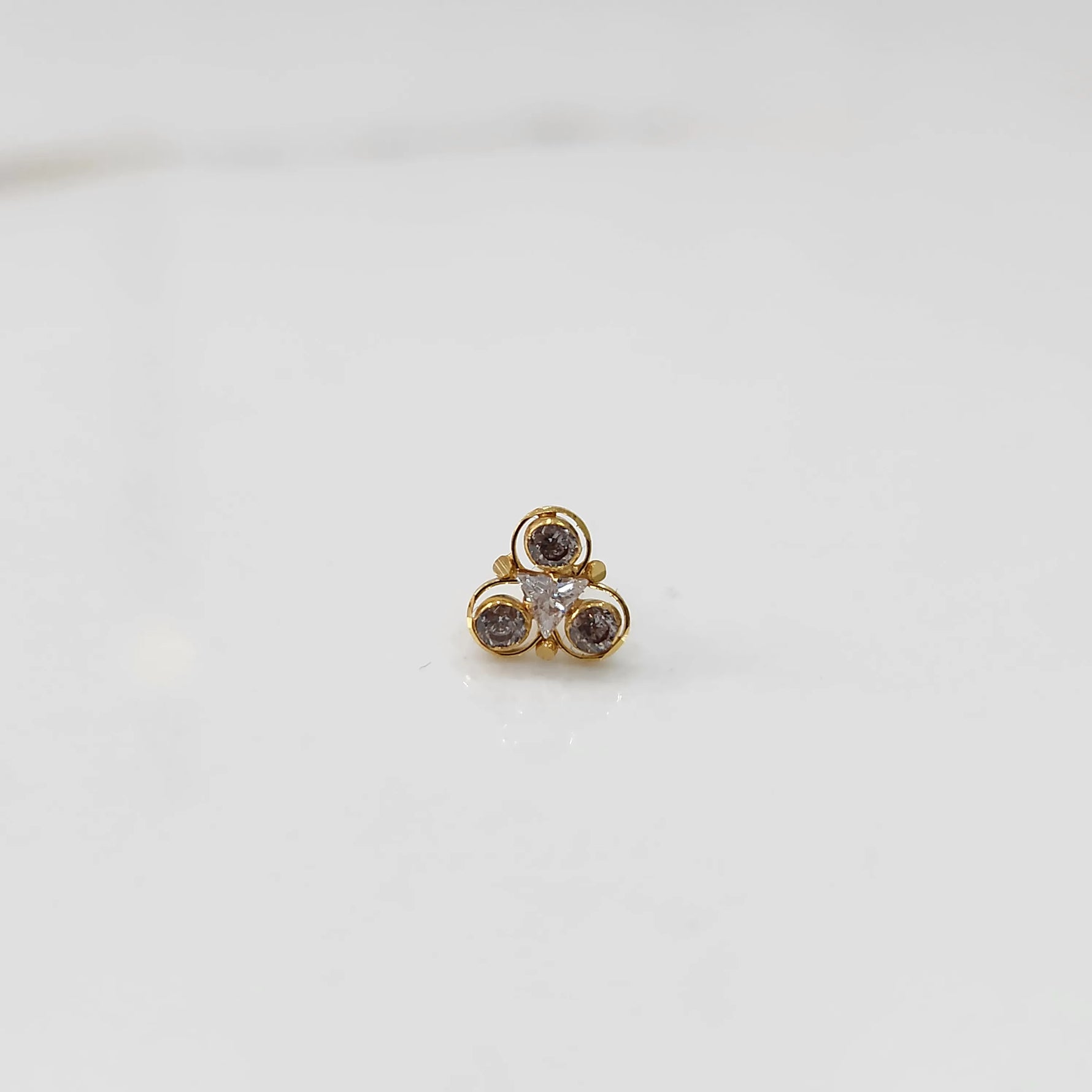 Top view of gold ring with brown and clear stone cluster