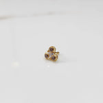 Gold ring with three-stone cluster in brown and clear stones