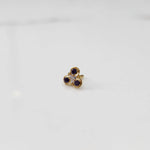 Gold ring with three-stone cluster in purple and clear stones