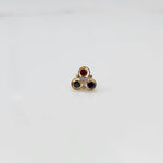 Top view of gold ring with ruby, sapphire and clear stone cluster