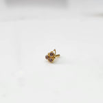 Gold statement ring with three purple-pink gemstones and leaf motif design