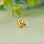 Open-work gold earring featuring branch and leaf detailing