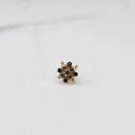 Stone gold nose pin angled view with soft lighting