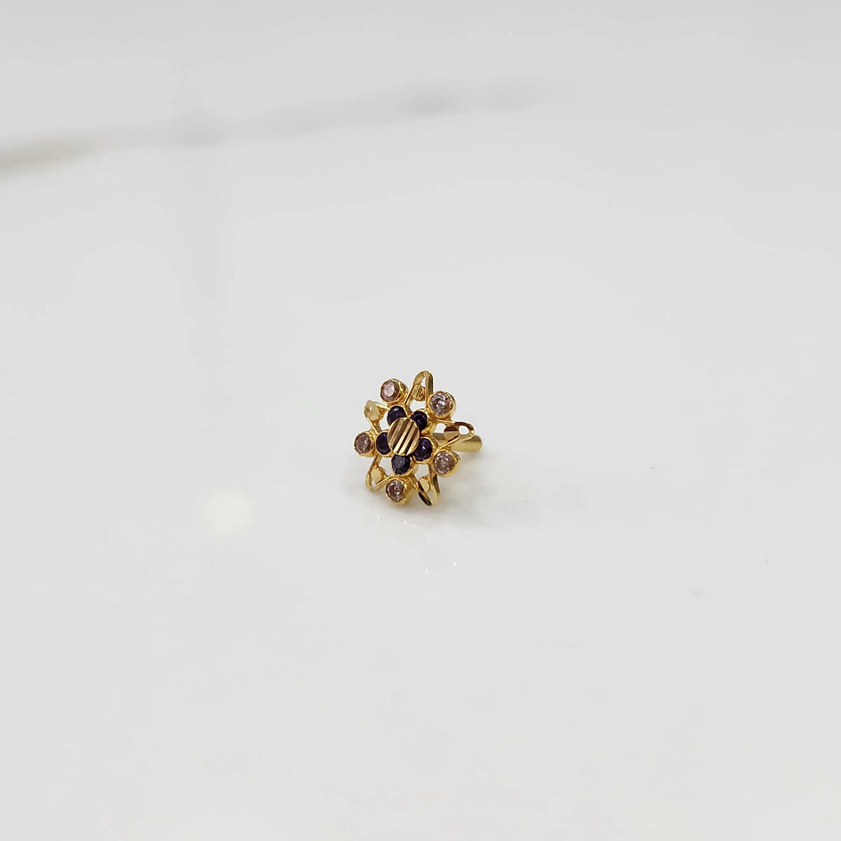 Gold cocktail ring with floral design and multicolor gemstone accents