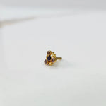 Front view of gold ring featuring black gemstone cluster with leaf accents