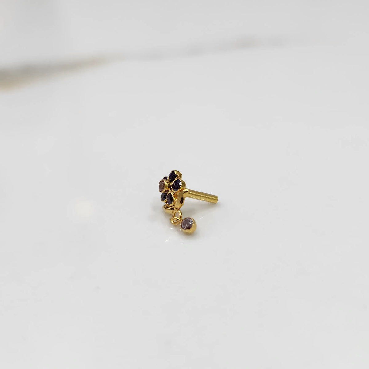 Antique-style gold ring with blue-toned stones in floral dangle pattern