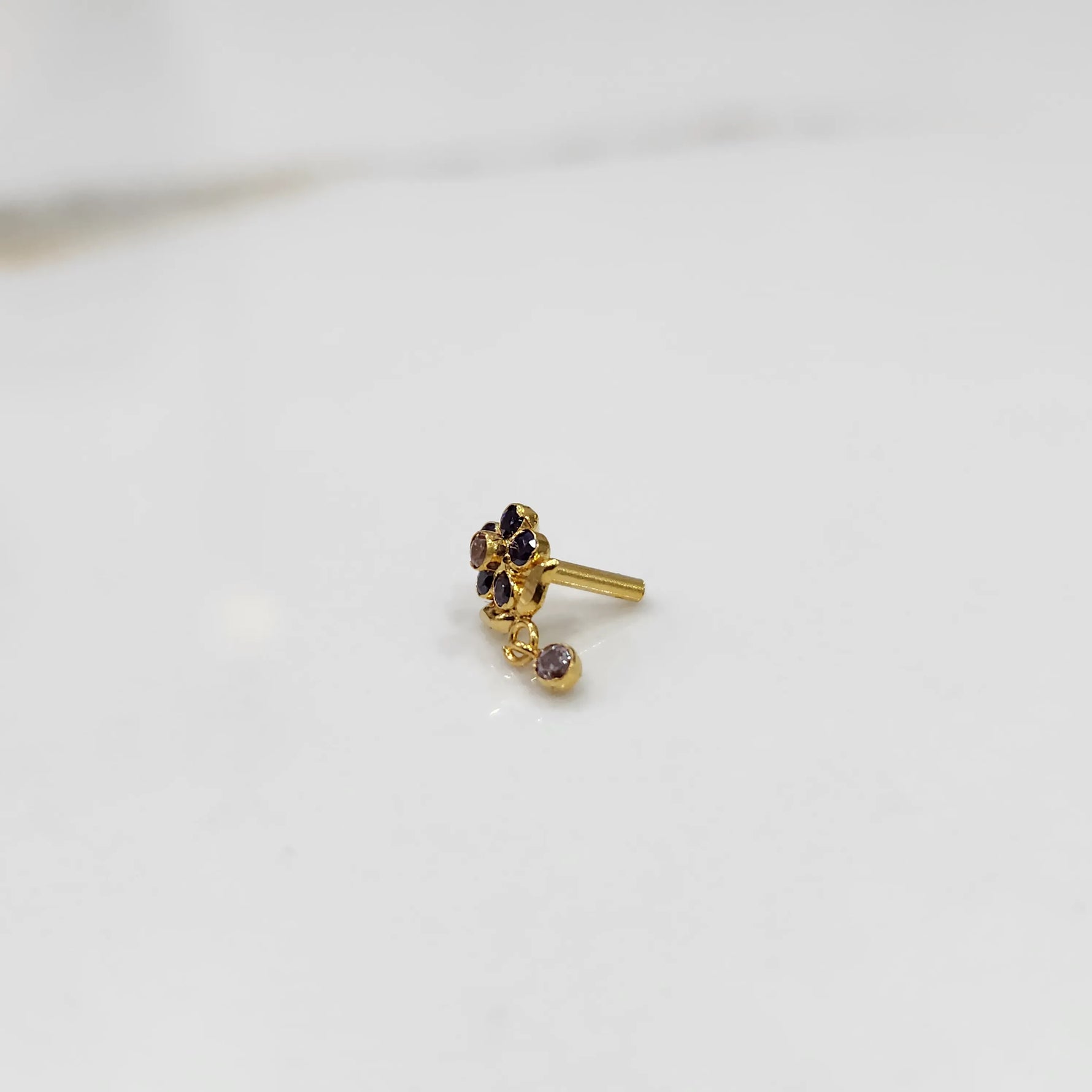 Antique-style gold ring with blue-toned stones in floral dangle pattern