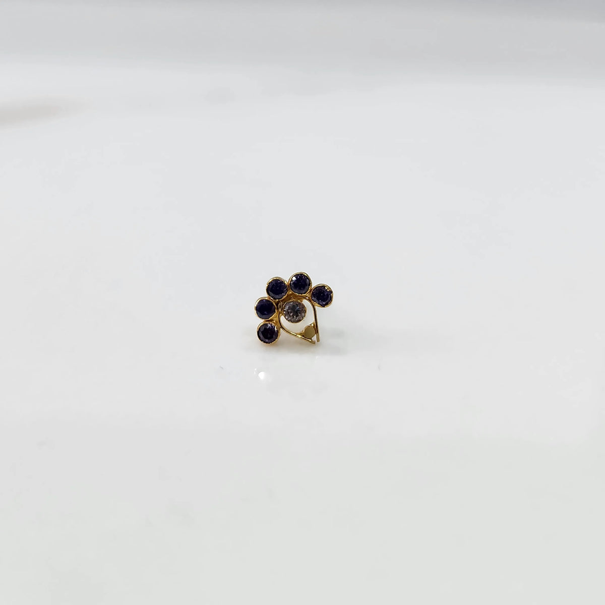 Gold ring with blue sapphire floral cluster design, front view