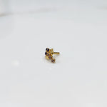 Side view of gold ring featuring blue gemstone cluster with leaf and drop accent