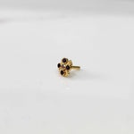 Top view of gold ring featuring blue gemstone flower with petal edges