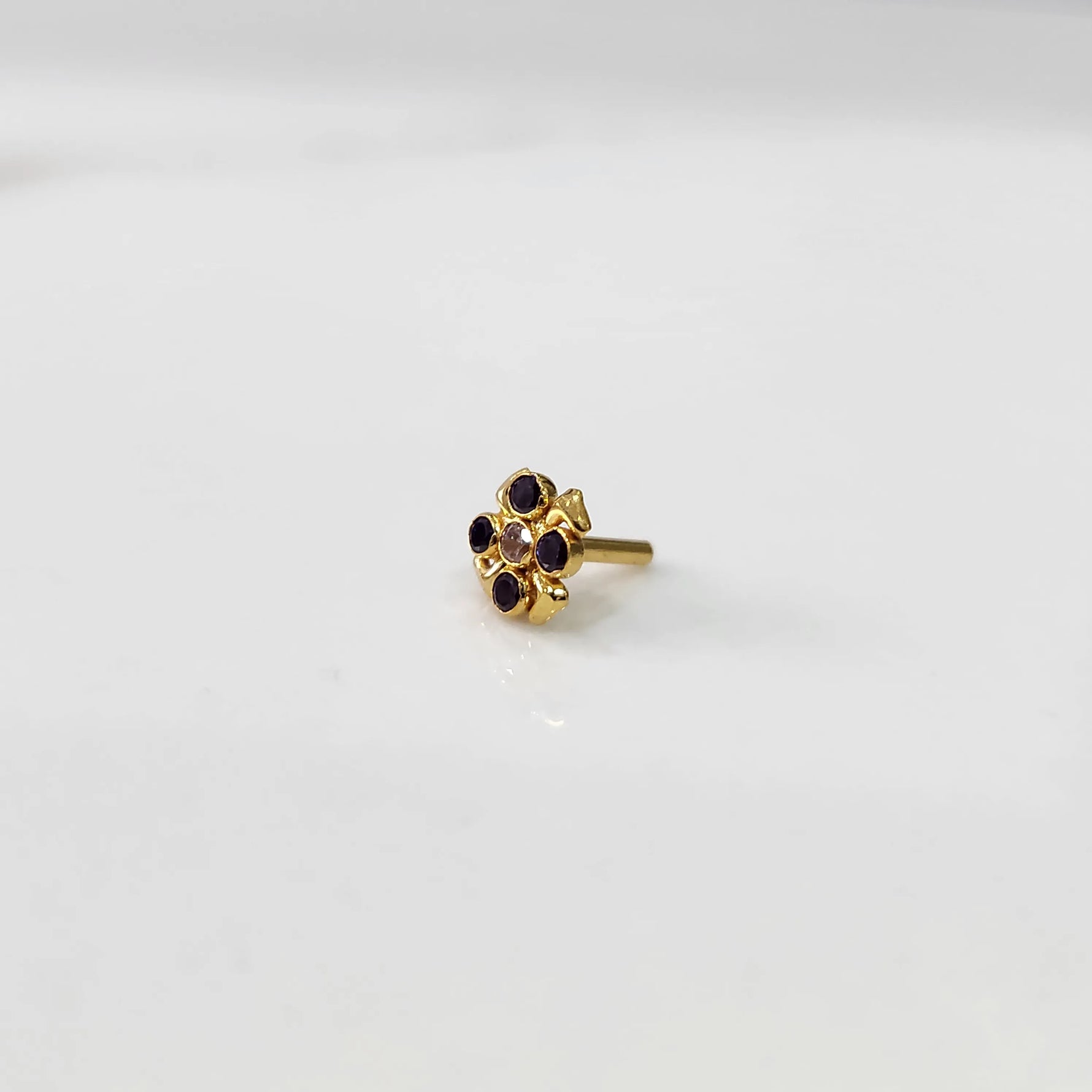 Top view of gold ring featuring blue gemstone flower with petal edges