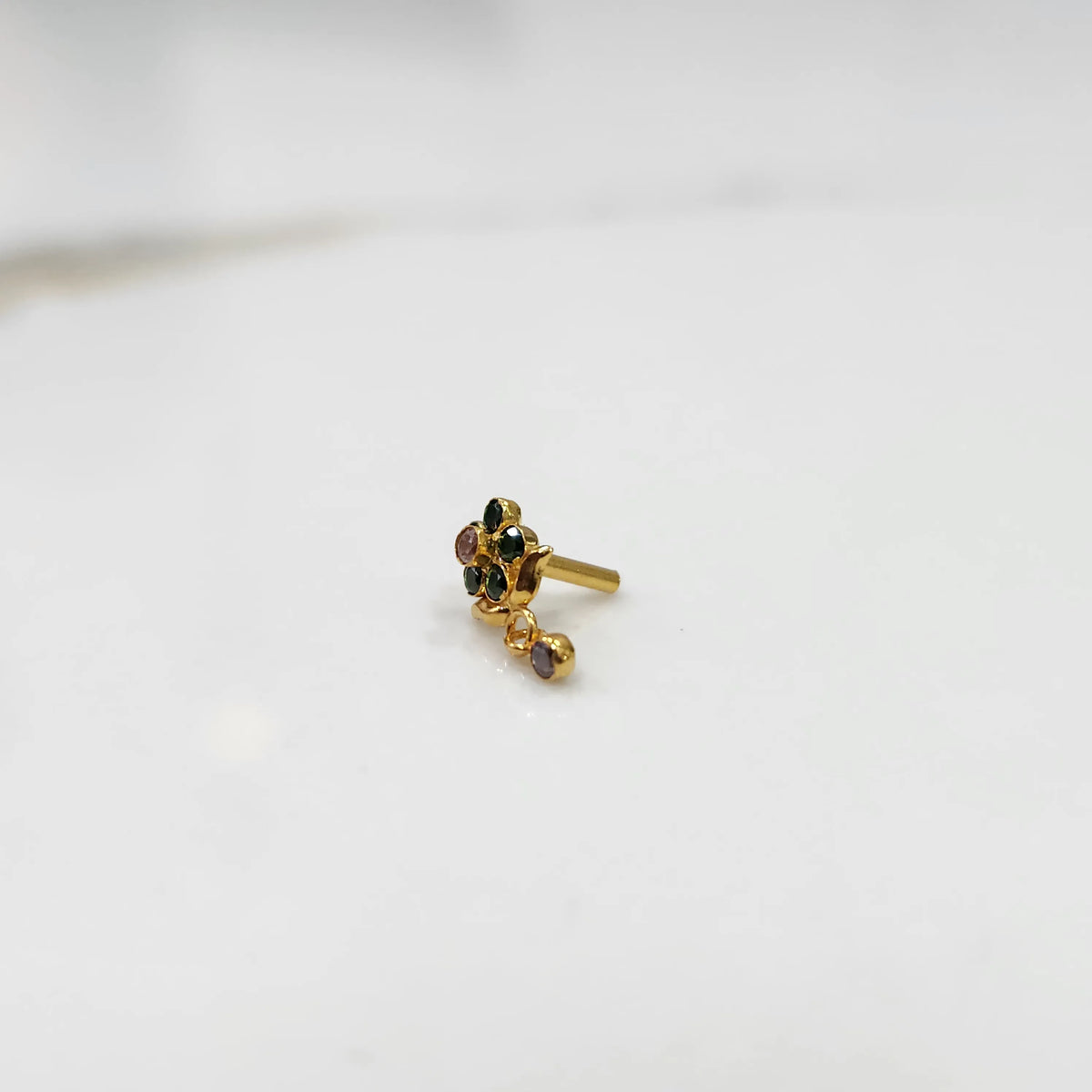 Antique-style gold ring with green-toned stones in floral dangle pattern