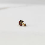 Antique-style gold ring with ruby, emerald, and sapphire stones plus hanging accent