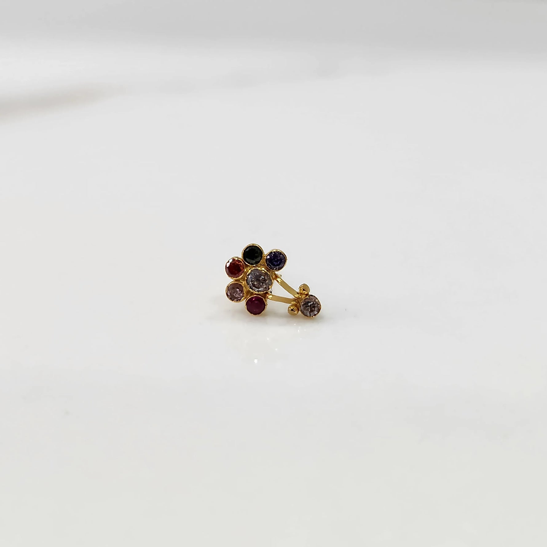 Antique-style gold ring with ruby, emerald, and sapphire stones plus hanging accent