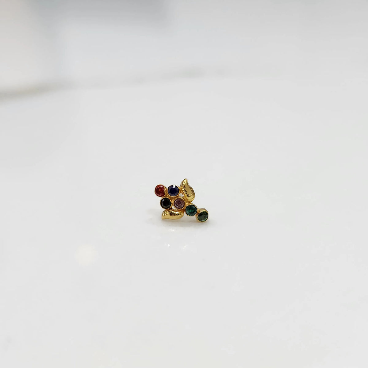Gold ring with multicolor gemstone leaf-charm cluster design, side view