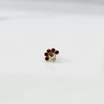 Antique-style gold ring with red-toned stones and CZ center