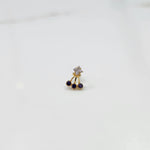 Antique-style gold ring featuring a square stone and hanging purple gems
