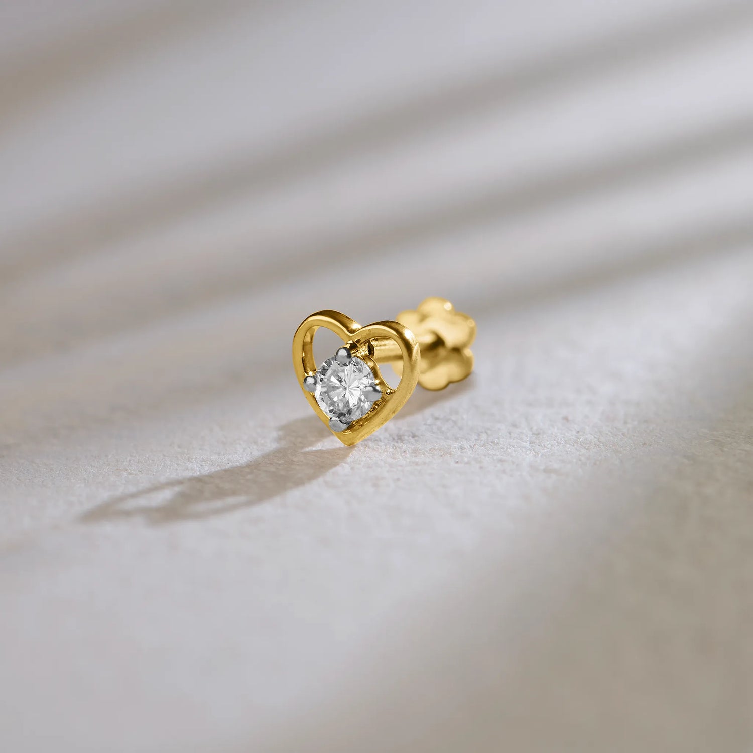 Heart-shaped diamond stud earring in 14k gold