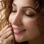 Woman wearing elegant gold nose pin close-up portrait