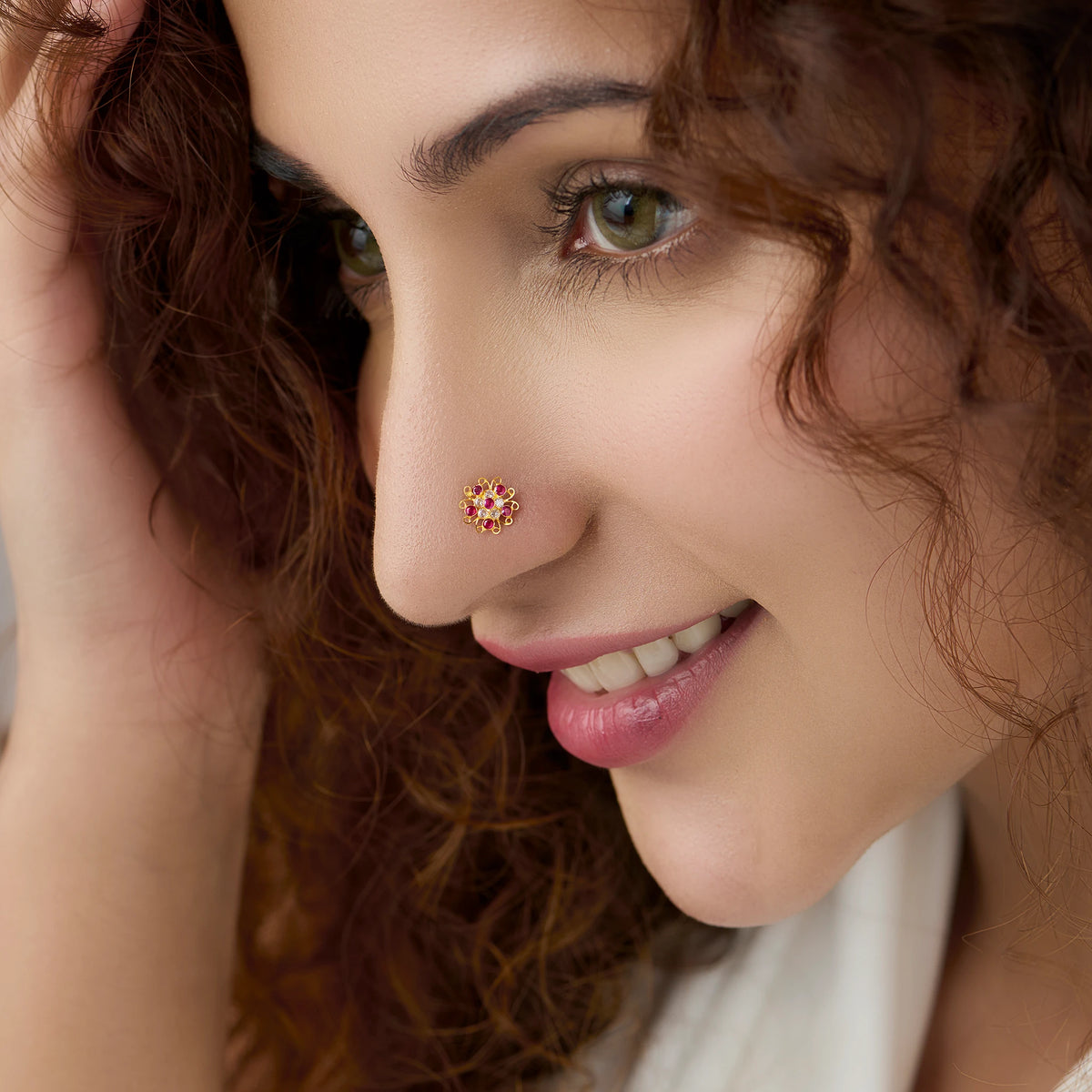 Woman wearing nose pin new design gold with floral diamond pattern close up