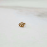 Close up of handcrafted teardrop gold nose pin design on white background elegant and modern in style