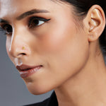 Woman wearing stylish teardrop gold nose pin design showcasing elegant and minimal indian jewellery look
