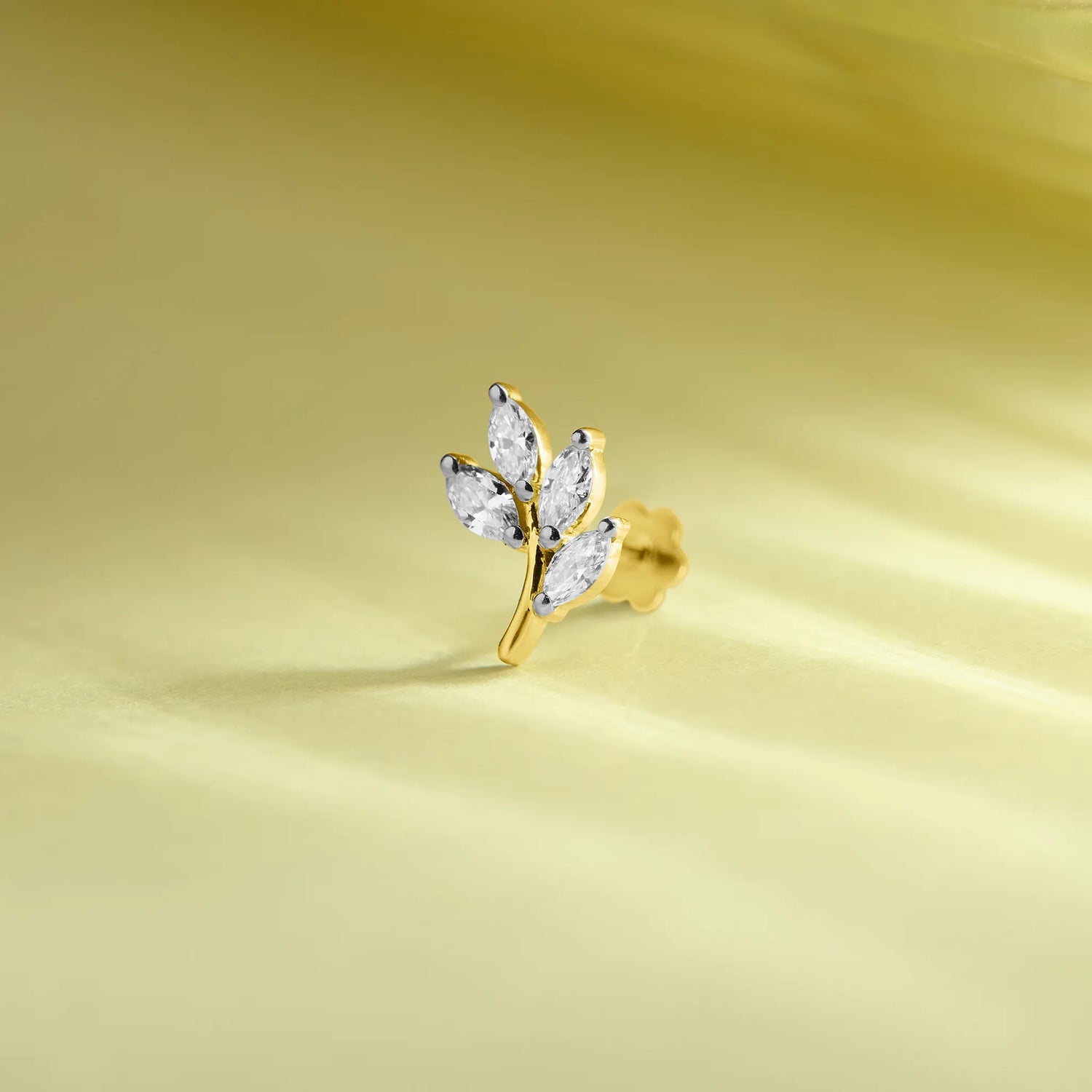 14k gold botanical stud earring featuring marquise diamond leaves on a branch