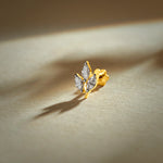 Flower nose pin gold with leaf-inspired floral design featuring sparkling marquise stones set in a polished gold base on a soft neutral background