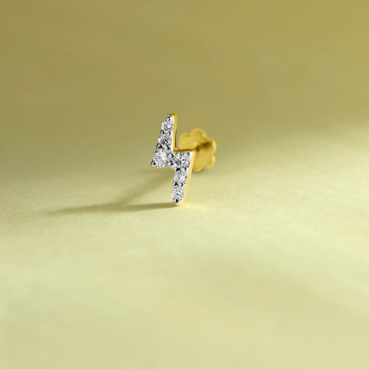 Lightning bolt-shaped diamond stud earring in 14k gold