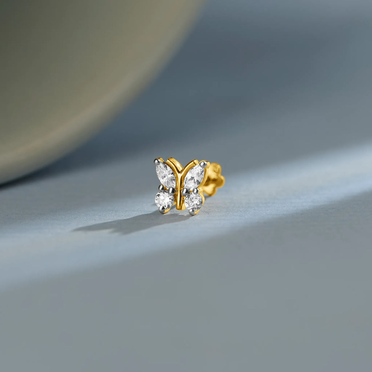 Lab grown diamond nose pin with butterfly design and sparkling diamonds on soft blue background