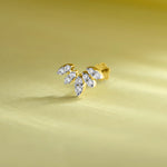 Fancy gold nose pin with leaf-shaped diamonds on pastel background