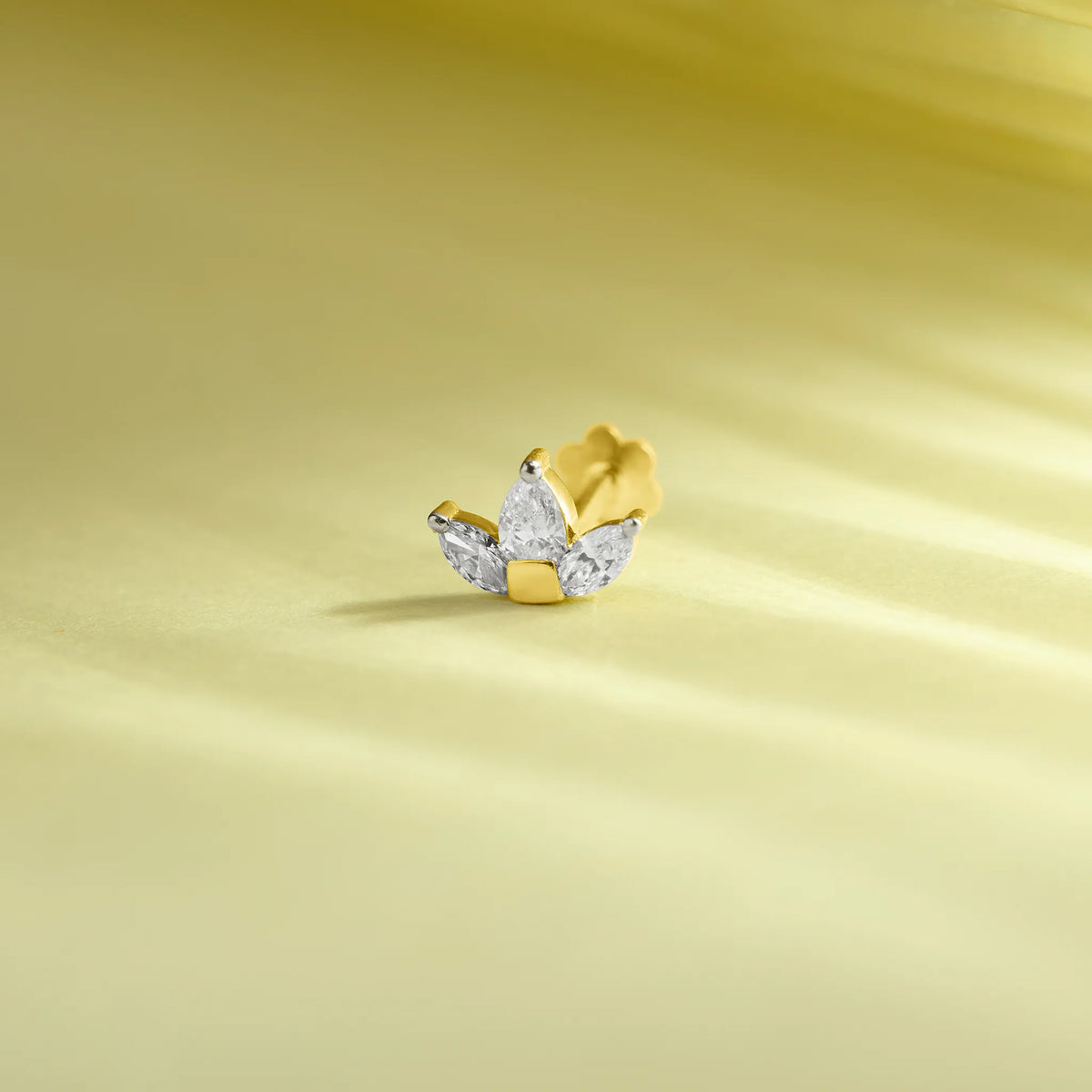 Diamond cluster stud earring with pear and marquise diamonds in a fan arrangement, gold