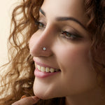 Model showcasing a delicate small blossom diamond nose pin