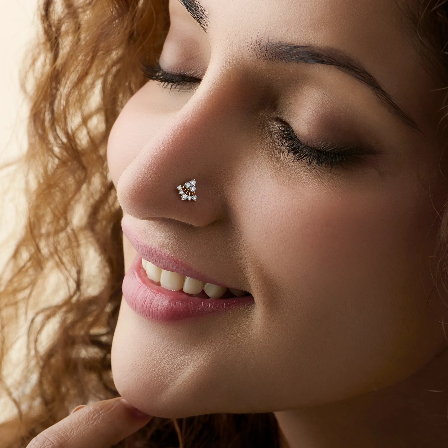 Woman wearing elegant triangle lab grown gold nose pin with diamond shine