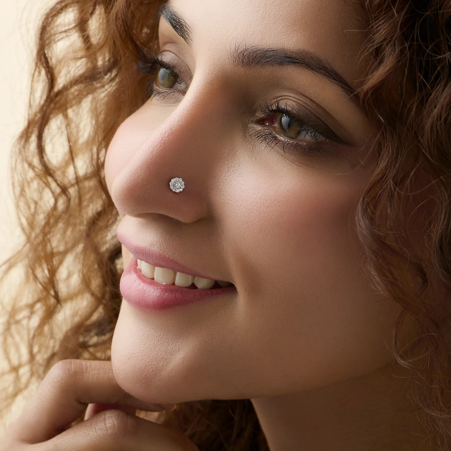 Woman wearing elegant round lab grown gold nose pin with sparkling diamond design
