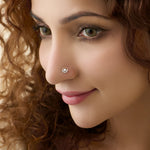 Woman wearing elegant gold nose pin design with sparkling diamond style