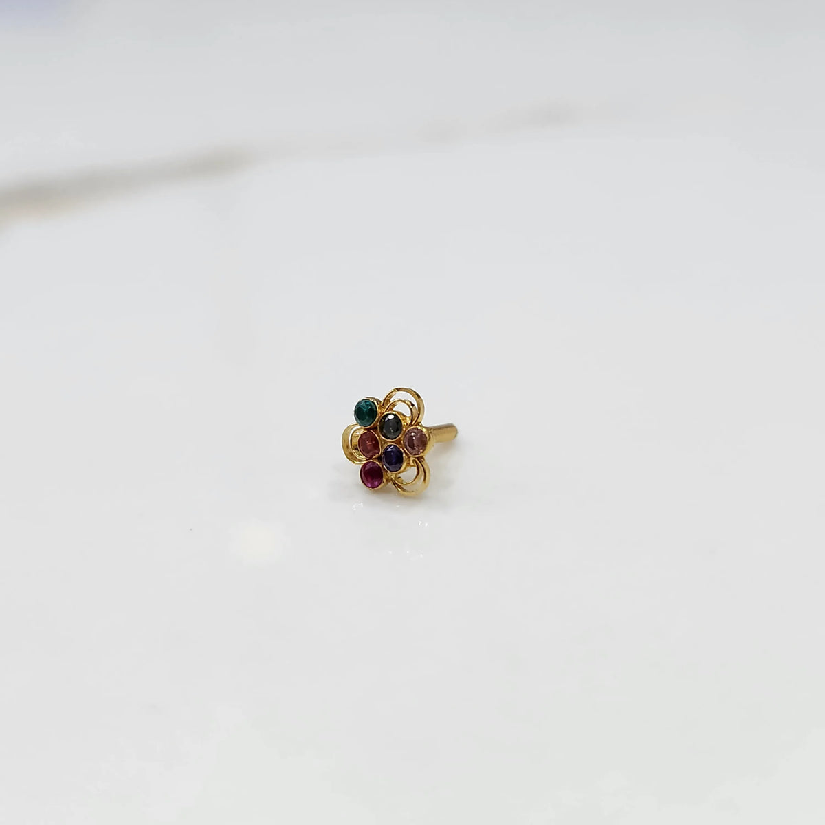 Another close front angle of the floral stone gold nose pin highlighting sparkle and finish