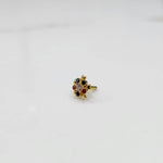 Product shot of a gold nose stud with multicolor gemstone flower cluster