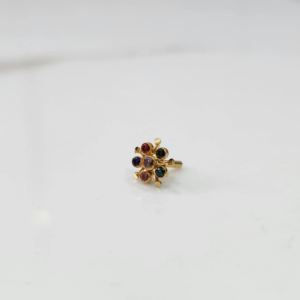 Gold floral nose pin with multicolor stone detailing