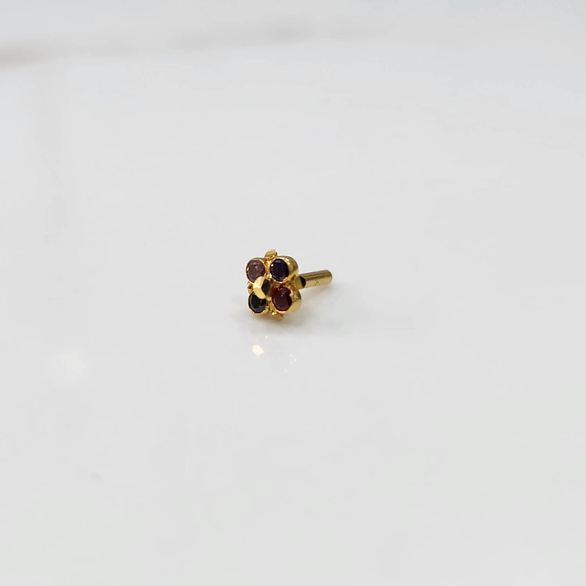 Gold flower nose pin with multicolor round stones