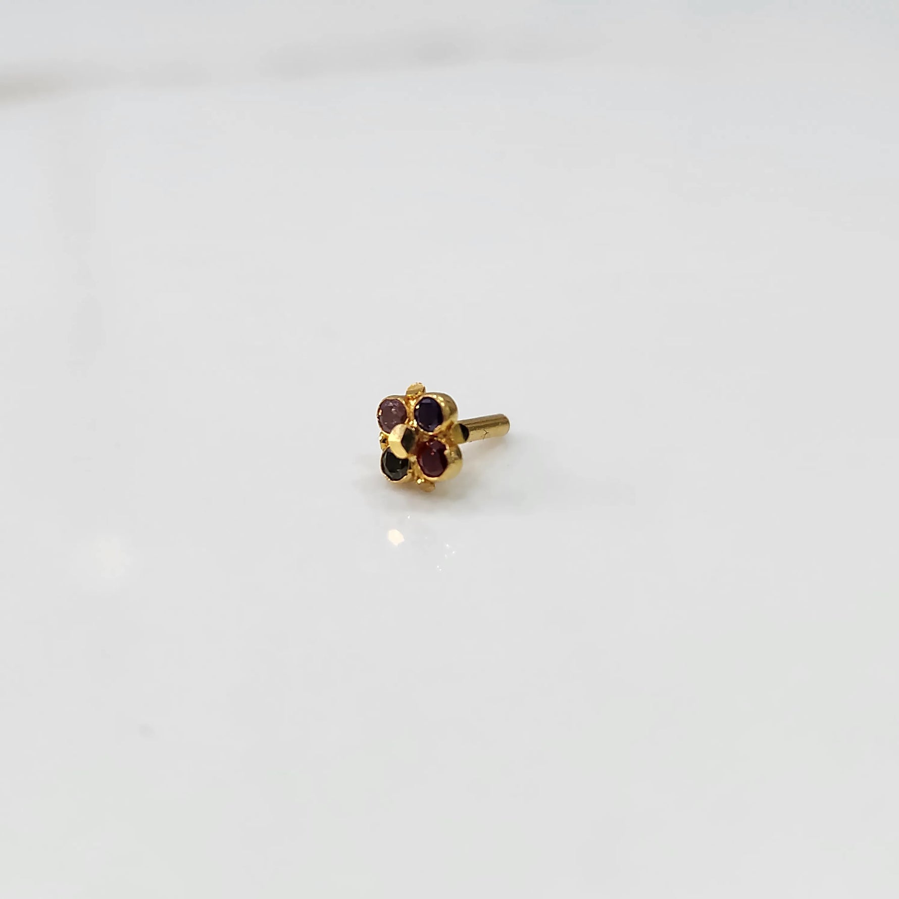Gold flower nose pin with multicolor round stones