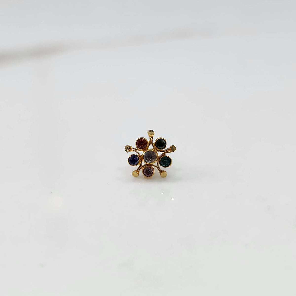 Gold nose pin with multicolor round stone detailing