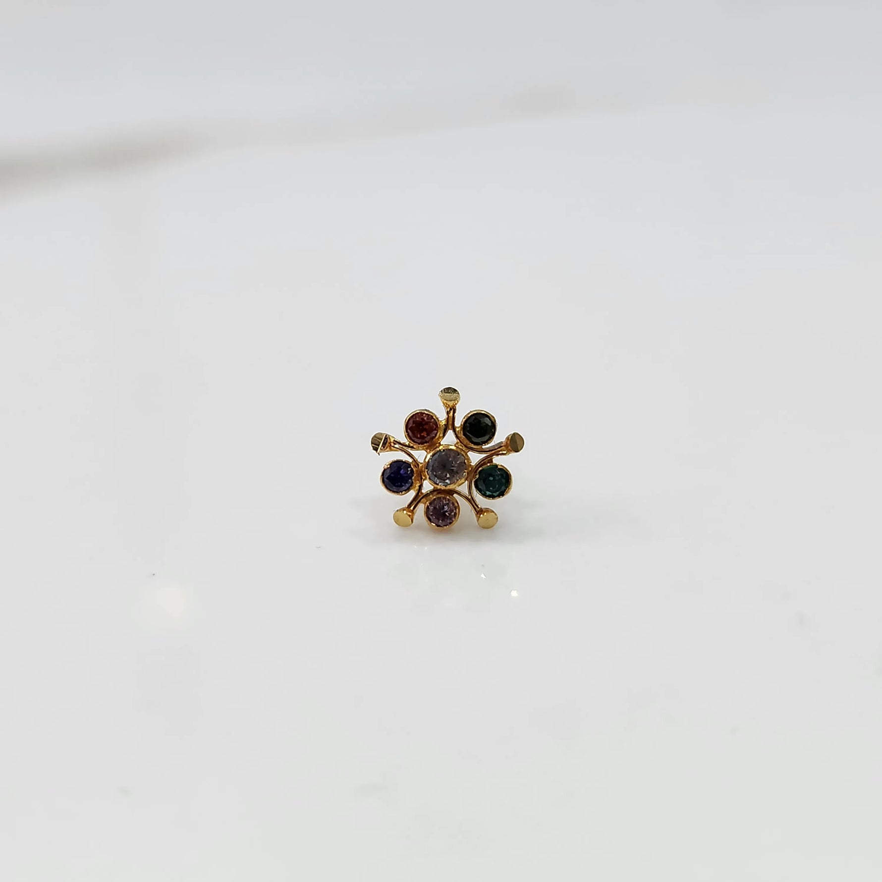 Gold nose pin with multicolor round stone detailing