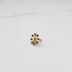 Traditional navratna nose pin with colorful gem cluster, jewelry photography