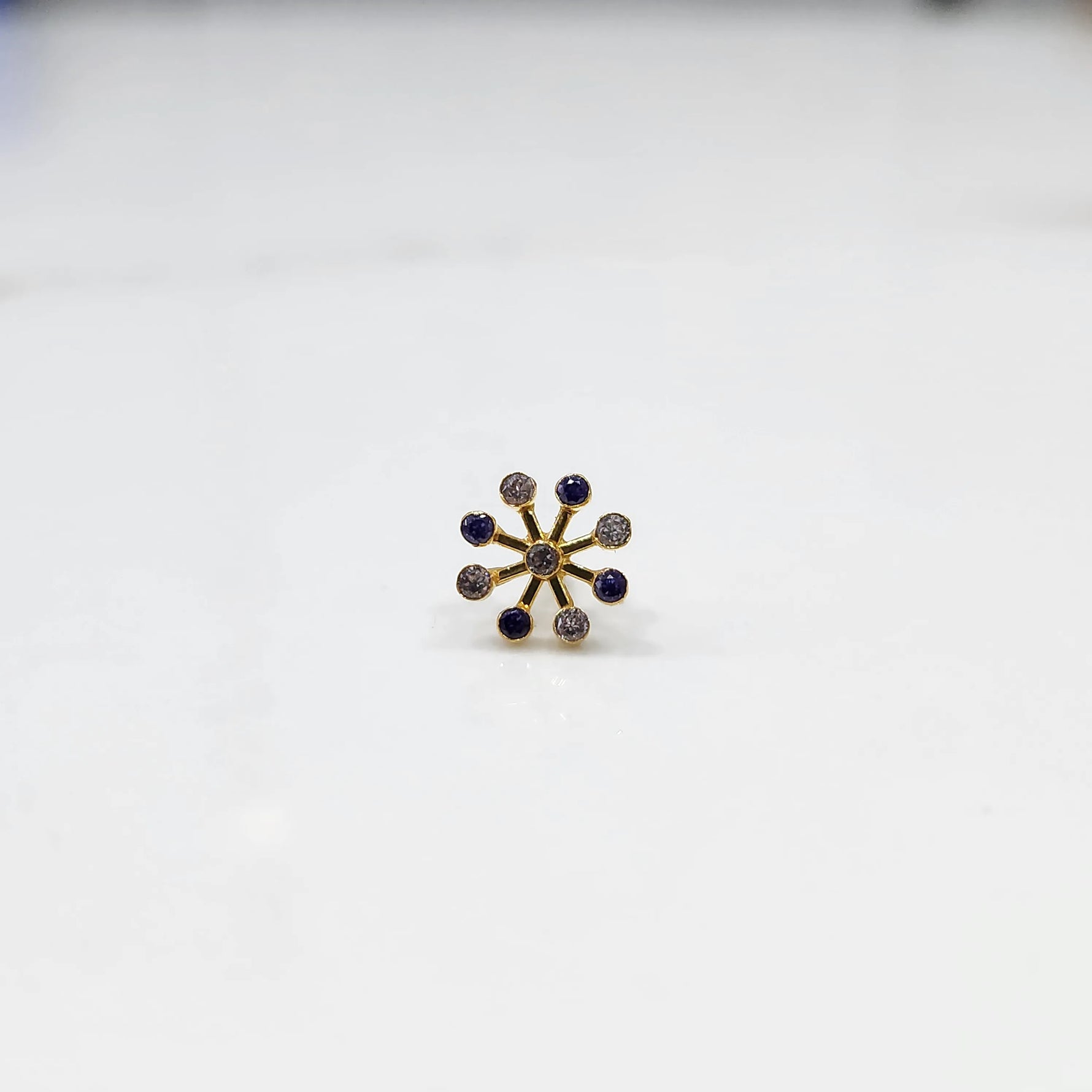 Close-up of a full-bloom purple gemstone cluster ring
