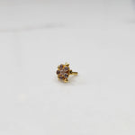 Clear CZ flower cluster nose stud with gold heart setting, jewelry photography