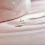 Round floral cluster gold nose pins with marquise and round diamonds on soft background