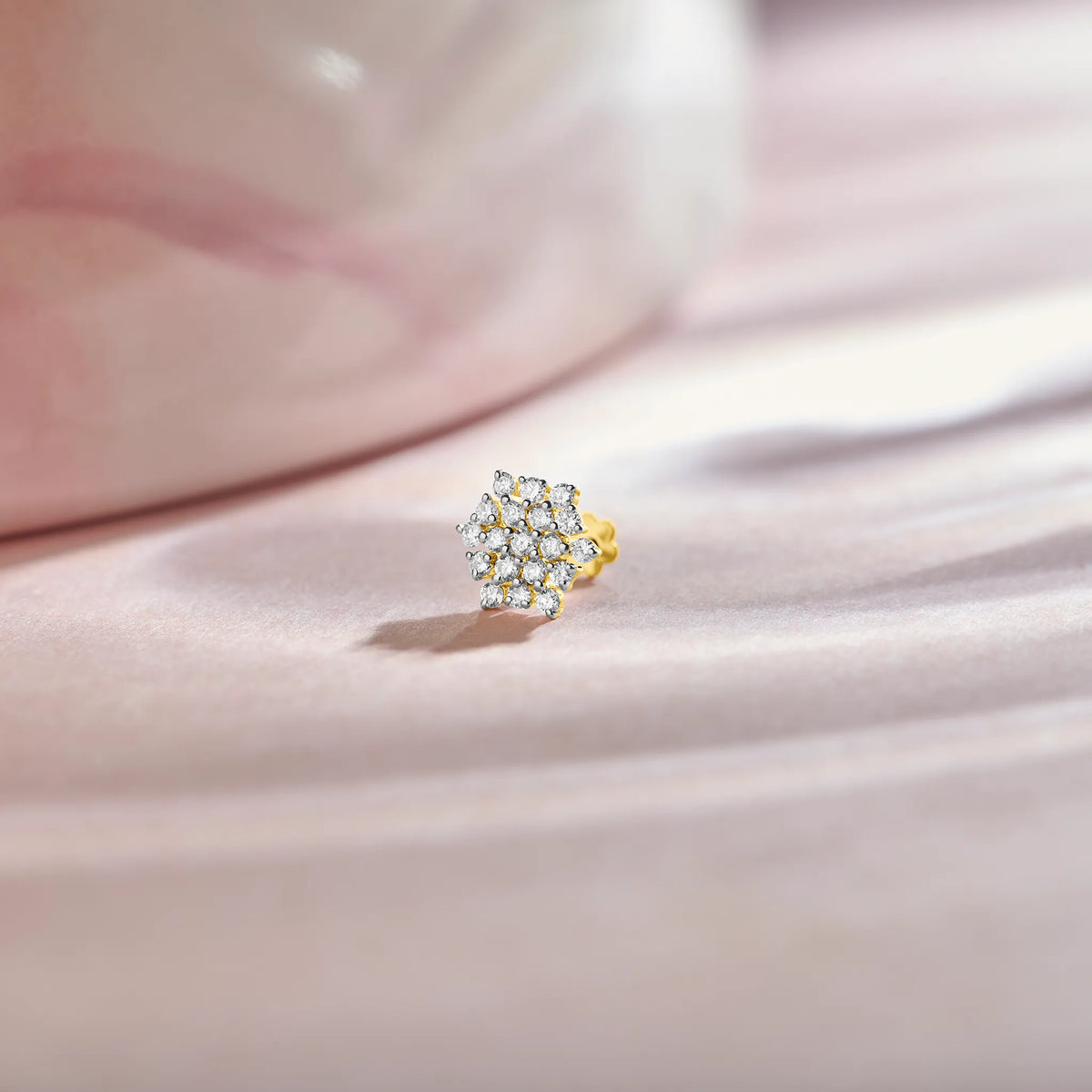 Round floral cluster gold nose pins with marquise and round diamonds on soft background